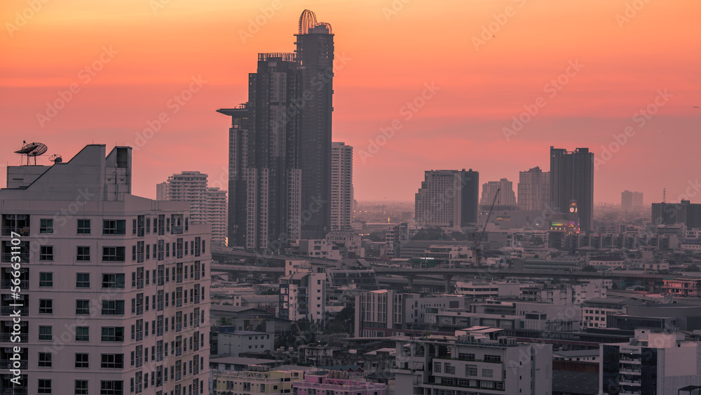 Fototapeta premium The high angle background of the city view with the secret light of the evening, blurring of night lights, showing the distribution of condominiums, dense homes in the capital community