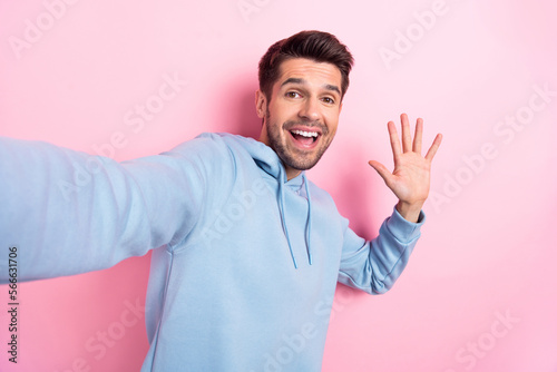 Photo of cool impressed man wear blue hoodie waving arm recording video vlog isolated pink color background © deagreez