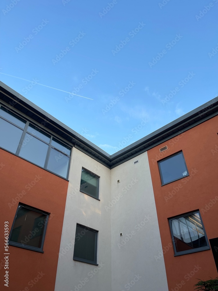 Low angle symmetric shot of a modern building under blue sky