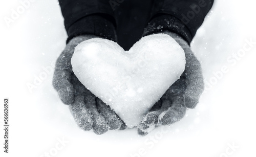 Close-Up of Female Hands Holding a Snow Heart on a Winter Day