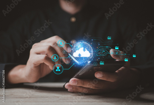 Cloud computing and technology concept.Man use Laptop with cloud computing diagram show on hand.Upload and download files. Data sharing and transfer network.