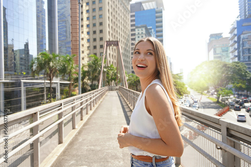 A surprised girl looks around in Sao Paulo metropolis, Brazil photo