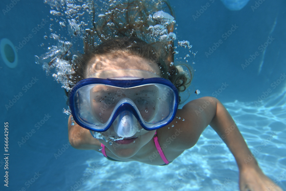 child swimming in a pool