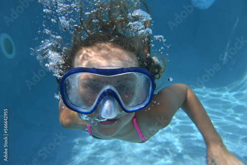 child swimming in a pool