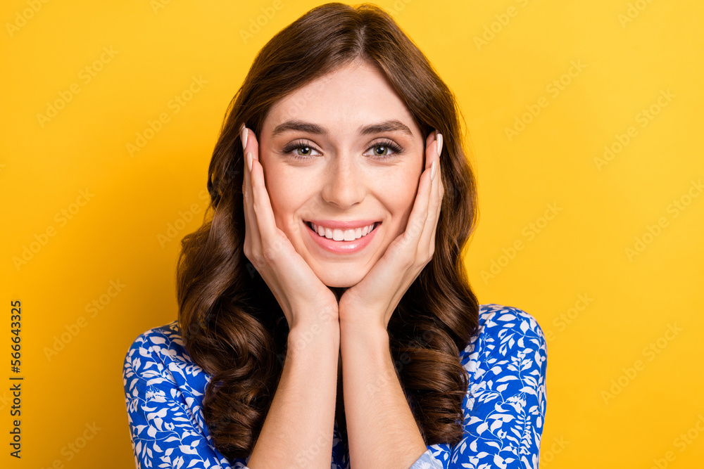 Closeup photo portrait of young cheerful dreamy lady wear blue shirt touch cheeks look satisfied you girlfriend isolated on yellow color background Closeup photo portrait of young cheerful dreamy lady wear blue shirt touch cheeks look satisfied you girlfriend isolated on yellow color background