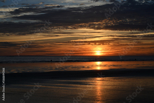 sunset under the clouds by the sea