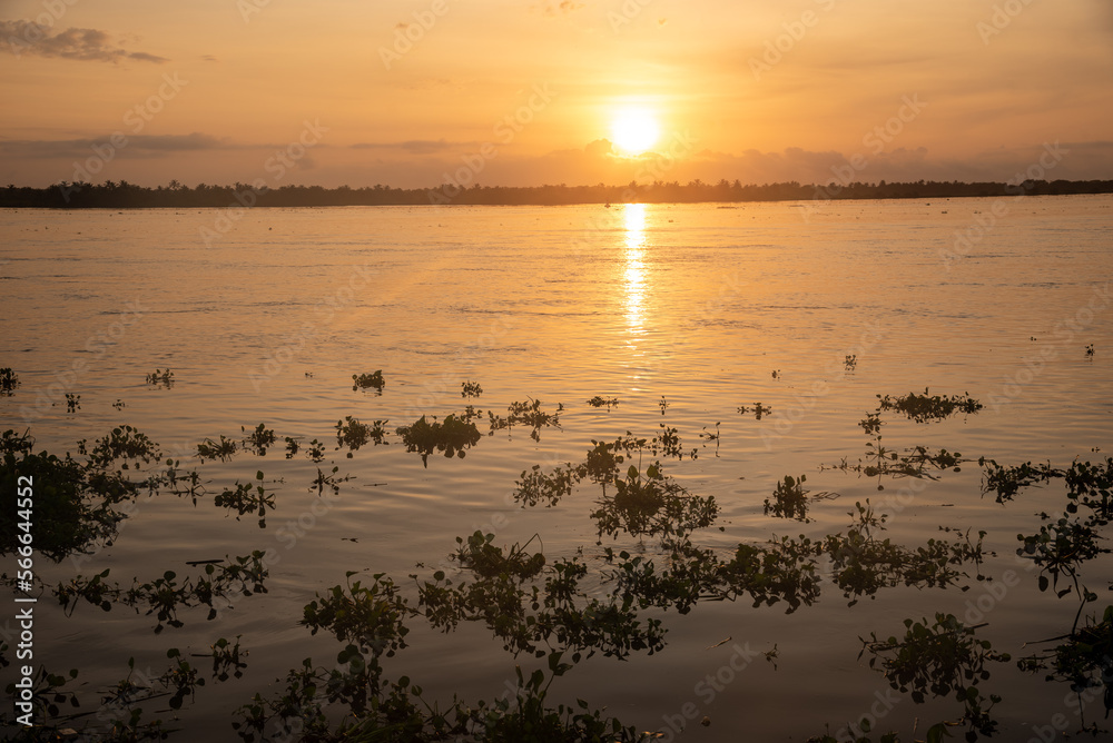 Sunrise over the Magdalena River in front of the Barranquilla boardwalk. Colombia.