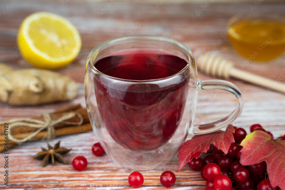 Healthy tea from from viburnum berries with lemon, honey and ginger. Close-up. Selective focus. Healthy tea from from viburnum berries with lemon, honey and ginger. Close-up. Selective focus.