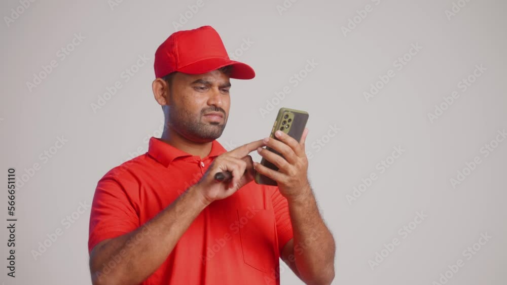 confused painter busy using mobile phone by holding paint brush at construction site - concept oftechnology, using app or application and renovation confused painter busy using mobile phone by holding paint brush at construction site - concept oftechnology, using app or application and renovation
