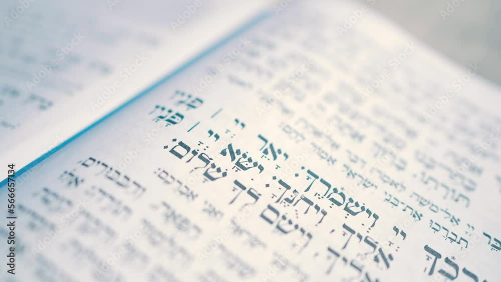 Close-up video recording of Hebrew words in the open Torah book. Prayer in Hebrew. Close-up video recording of Hebrew words in the open Torah book. Prayer in Hebrew.