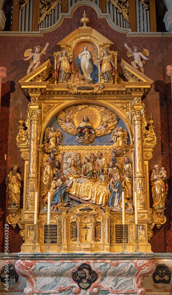 LUZERN, SWITZERLAND - JUNY 24, 2022: The carved polychrome side altar of Dormition of Virgin Mary in the church St. Leodegar im Hof by Niklaus Geisler (1585-1665)