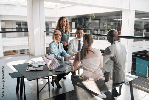 Diverse businesspeople laughing during an office meeting