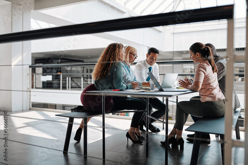 Smiling businesspeople discussing work during an office meeting
