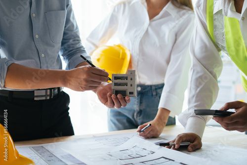 Close up view of Engineers and Architect working together on construction project.