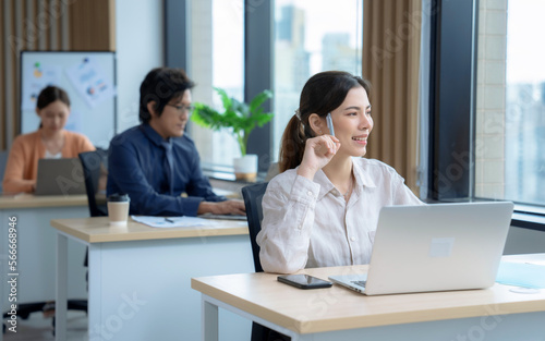 Group of business people sitting and working in modern office.