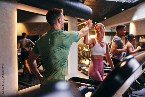 People high-fiving at the gym