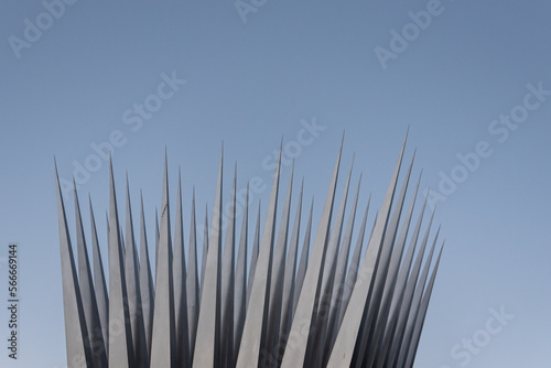 Close up of steel needles or pins against a clear blue sky