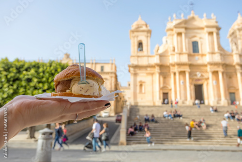 Brioche with ice cream in piazza del Duomo in Noto, Sicily