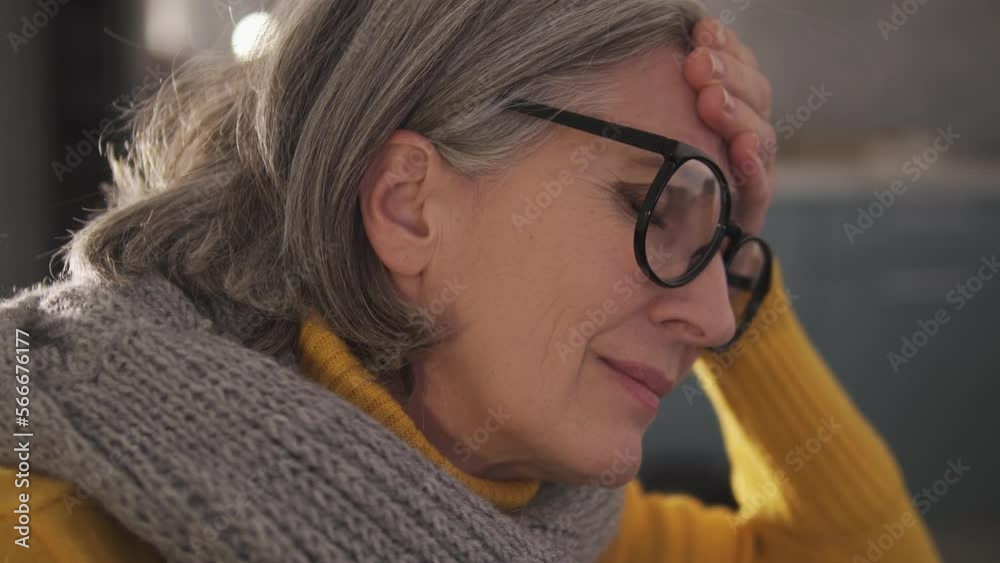 Deeply upset frustrated woman with gray hair and in big eyeglasses rubbing sore forehead, feeling unbearable headache, suffering migraine, high blood pressure, close-up lady face Deeply upset frustrated woman with gray hair and in big eyeglasses rubbing sore forehead, feeling unbearable headache, suffering migraine, high blood pressure, close-up lady face