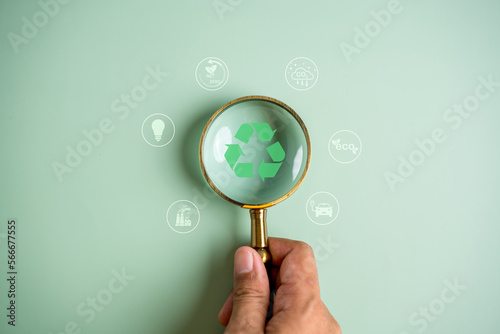 Magnifier focus to recycling icon on global earth decrease CO2 or carbon dioxide emission, carbon footprint and carbon credit to limit global from climate change, Earth for develop green energy