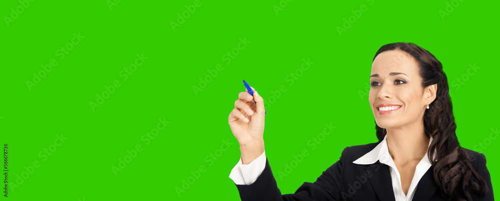 Happy smiling cheerful beautiful young business woman writing or drawing something on screen or transparent glass, by blue marker. Green chroma key background. Happy smiling cheerful beautiful young business woman writing or drawing something on screen or transparent glass, by blue marker. Green chroma key background.