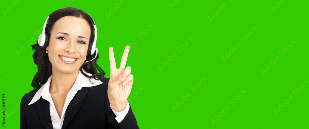 Call center service. Customer support phone sales operator in headset showing two fingers or victory gesture. Green chroma key background. Call center service. Customer support phone sales operator in headset showing two fingers or victory gesture. Green chroma key background.