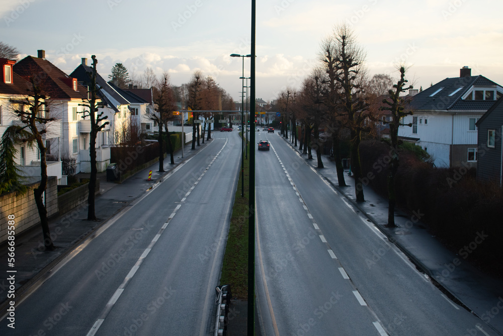 Twin two lane roads through small town shot from bride with aerial view Twin two lane roads through small town shot from bride with aerial view