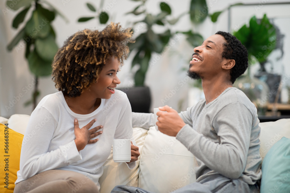 Happily married african couple drinking coffee at home Happily married african couple drinking coffee at home