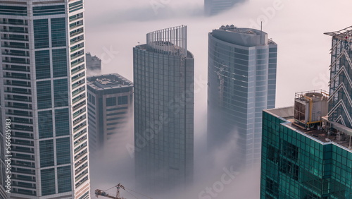 Rare early morning winter fog above the Dubai Marina skyline and skyscrapers rooftops aerial .