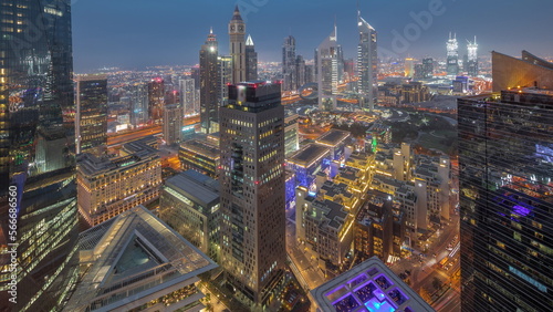 Panorama of futuristic skyscrapers after sunset in financial district business center in Dubai day to night