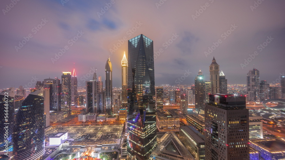 Panorama of futuristic skyscrapers after sunset in financial district business center in Dubai day to night