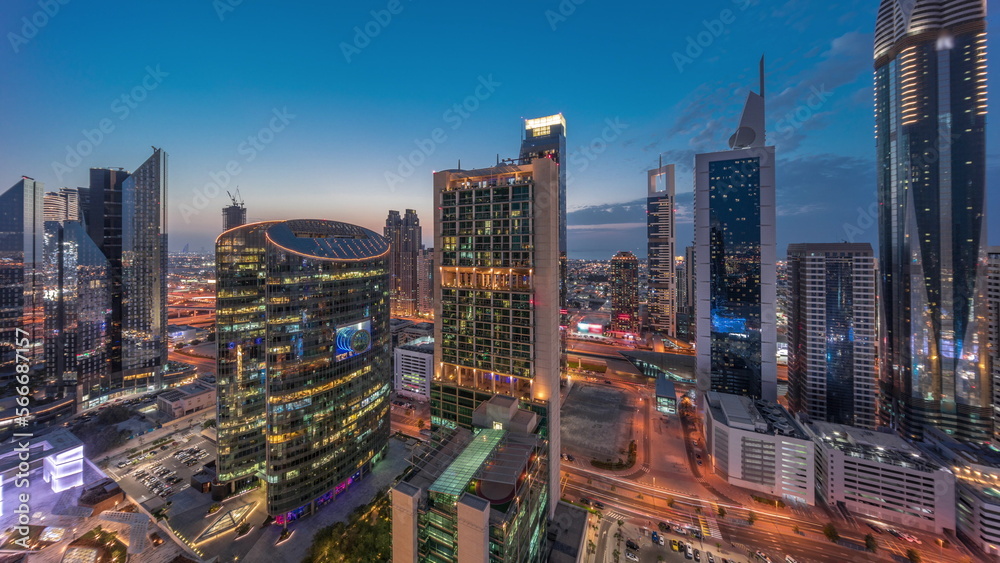 Dubai international financial center skyscrapers aerial day to night .