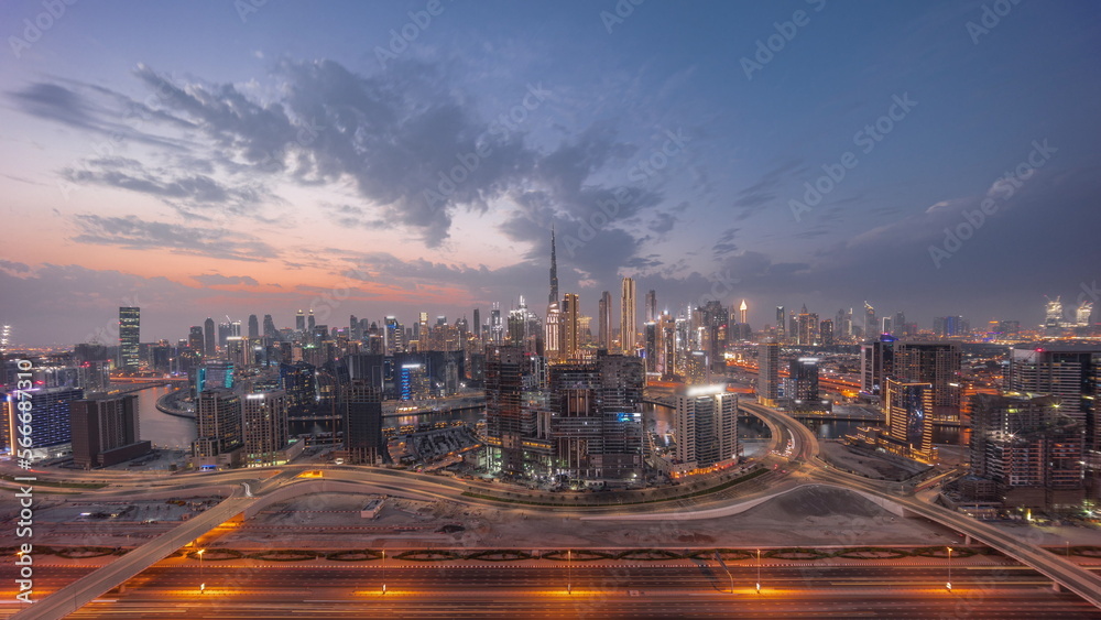 Fototapeta premium Panoramic skyline of Dubai with business bay and downtown district day to night .