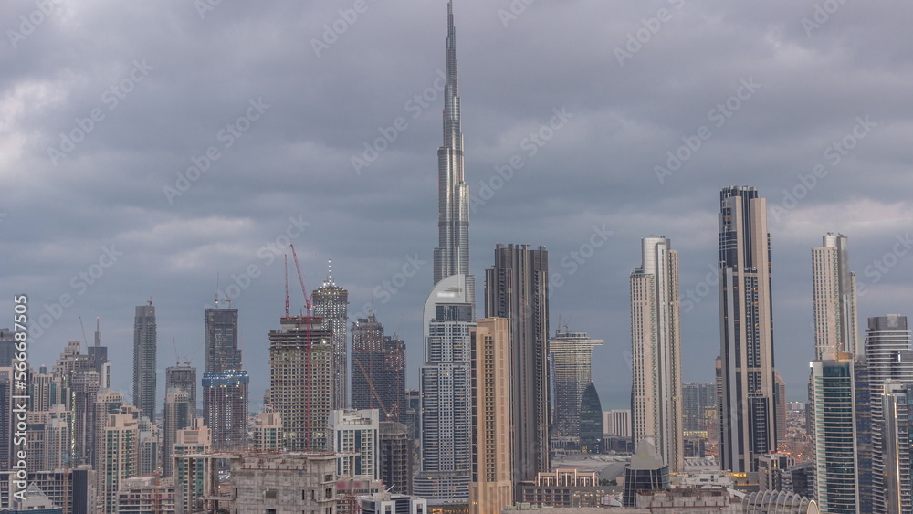 Panoramic skyline of Dubai with business bay and downtown district night to day .
