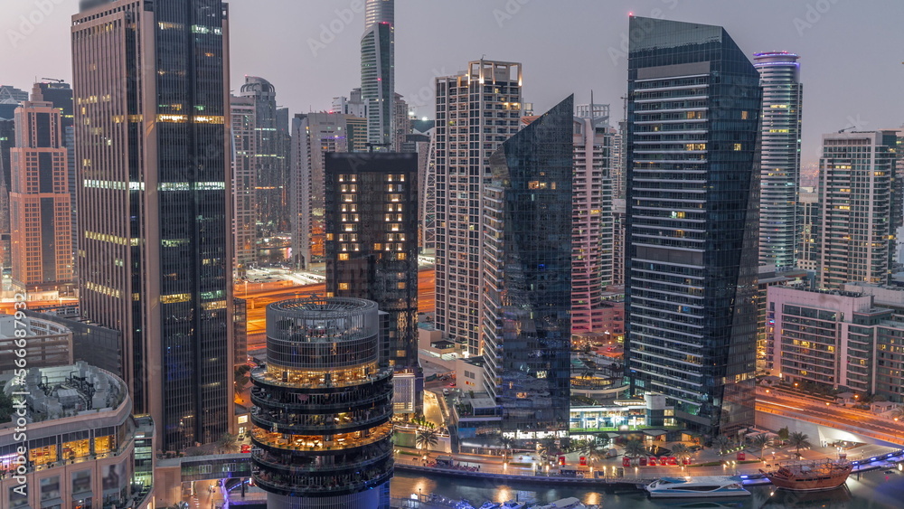 Dubai Marina Skyline with JLT district skyscrapers on a background aerial night to day .