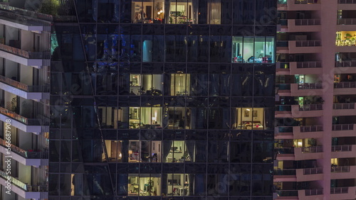 Windows lights in modern office and residential buildings at night