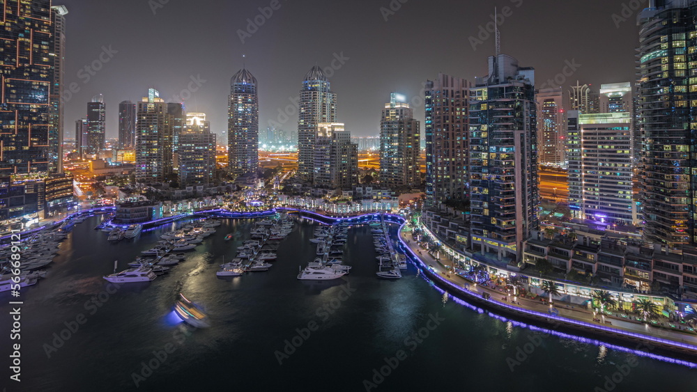 Panorama showing luxury yacht bay in the city aerial night in Dubai marina