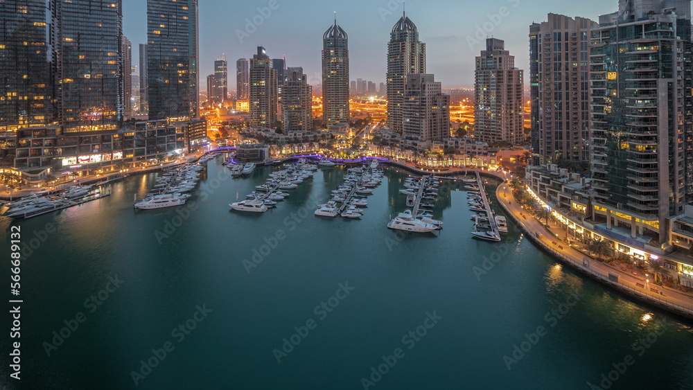 Fototapeta premium Luxury yacht bay in the city aerial night to day in Dubai marina