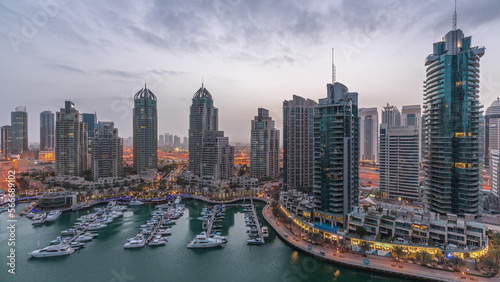 Luxury yacht bay in the city aerial night to day in Dubai marina