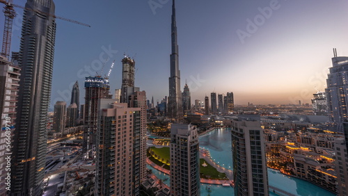 Dubai Downtown cityscape with tallest skyscrapers around aerial night to day .