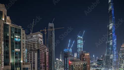Panorama showing aerial cityscape night with illuminated architecture of Dubai downtown.