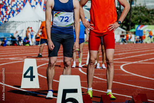 blind male runner with guide running sprint race photo