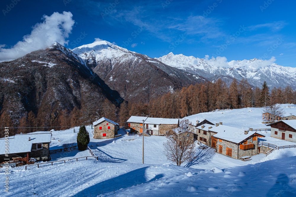 The Valtellina mountains, with its pastures, woods and fresh snow, during a wonderful winter day near the village of Sondrio, Italy - January 2023.