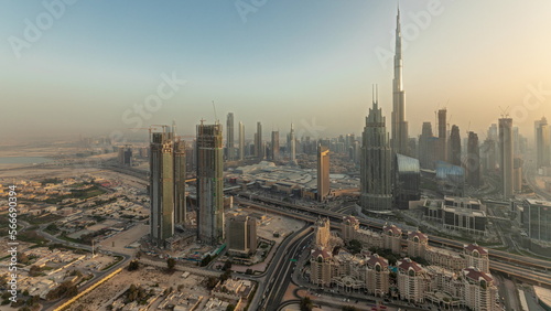 Panorama showing aerial view of tallest towers in Dubai Downtown skyline and highway .