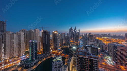 Panorama of various skyscrapers in tallest recidential block in Dubai Marina aerial night to day