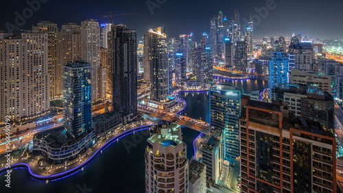 Panorama showing various skyscrapers in tallest recidential block in Dubai Marina aerial night