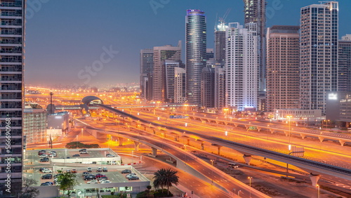 Dubai Marina skyscrapers and Sheikh Zayed road with metro railway aerial night to day , United Arab Emirates © neiezhmakov