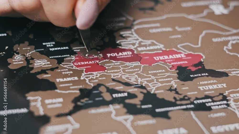 Female Hand Scratching Germany Country on the Surface of Scratch World