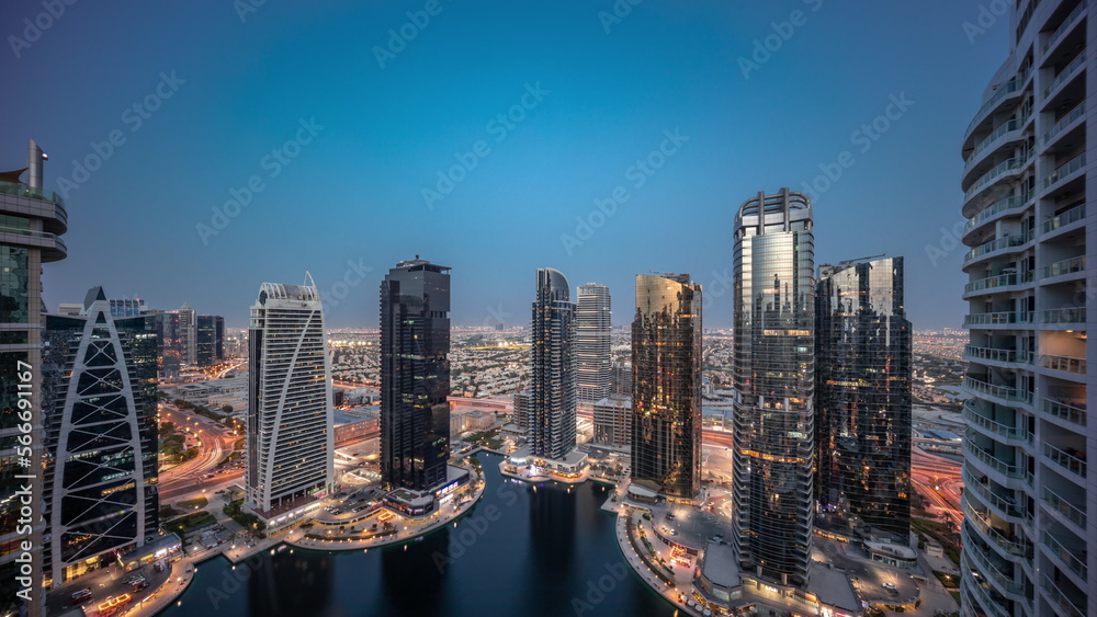Tall residential buildings at JLT aerial day to night , part of the Dubai multi commodities centre mixed-use district.