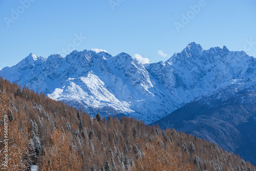 The Valtellina mountains, with its pastures, woods and fresh snow, during a wonderful winter day near the village of Sondrio, Italy - January 2023.